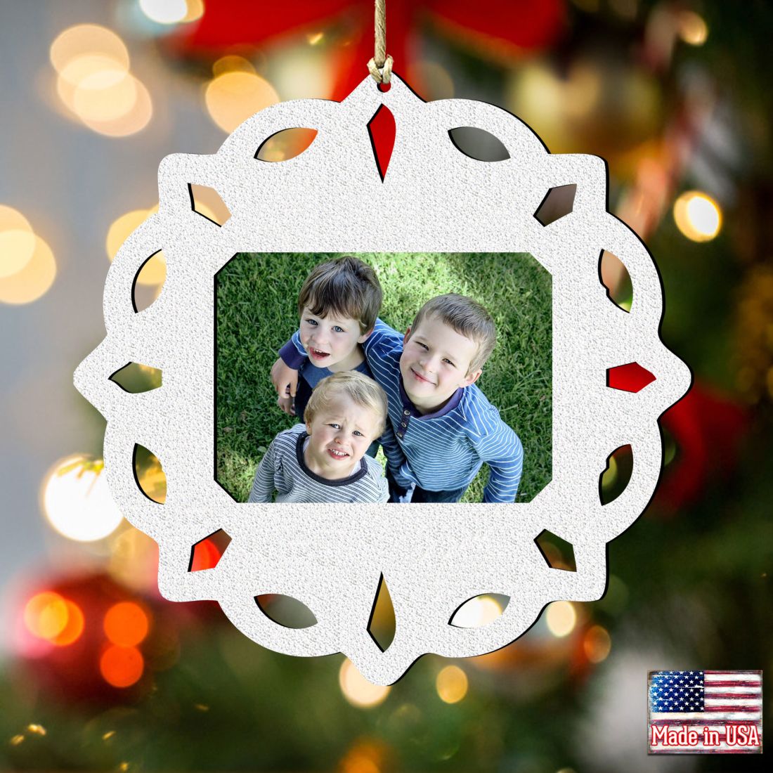 Wooden handcrafted snowflake Christmas tree ornament holding a small rectangular family photograph inside — view 3