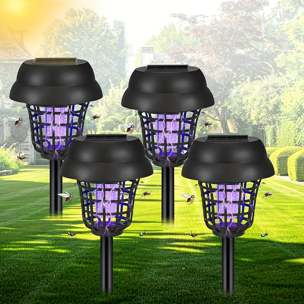 Four outdoor solar powered UV mosquito repellent lamps staked into green grass — view 2