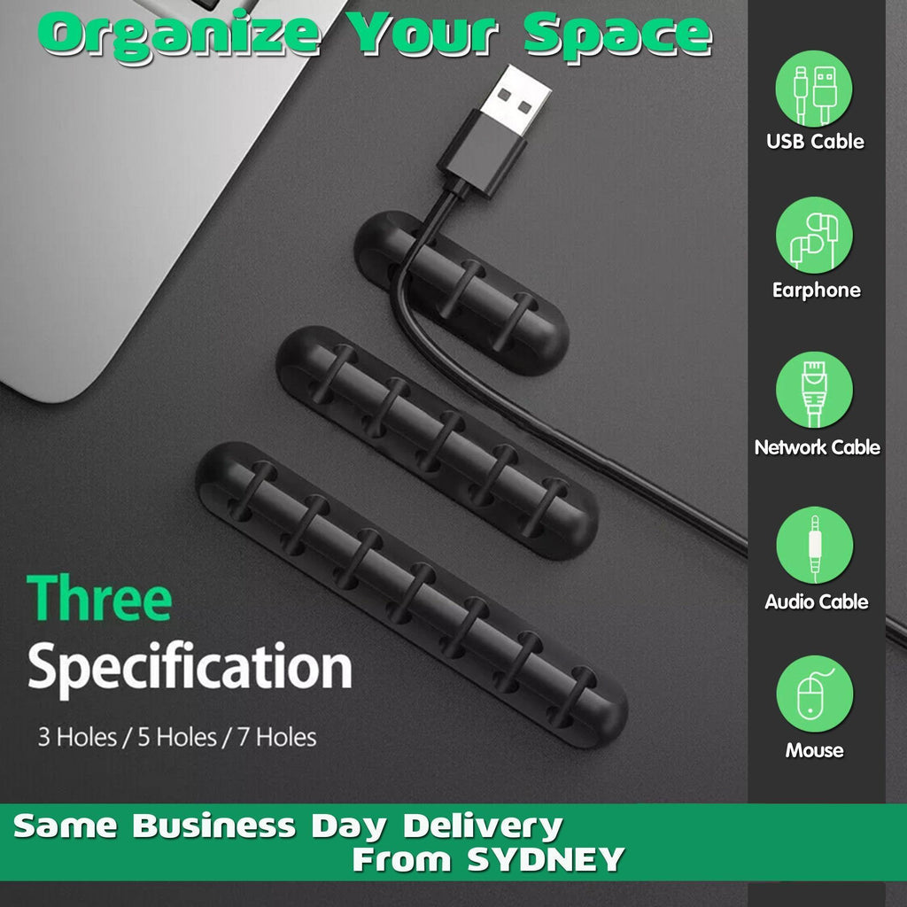 Silicone desk cable organizer clips holding various USB and charging cords on a flat surface
