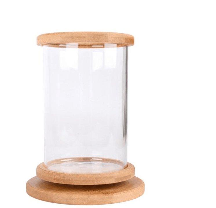 Mini glass cylindrical fish tank with a natural spliced bamboo base on a table — view 4