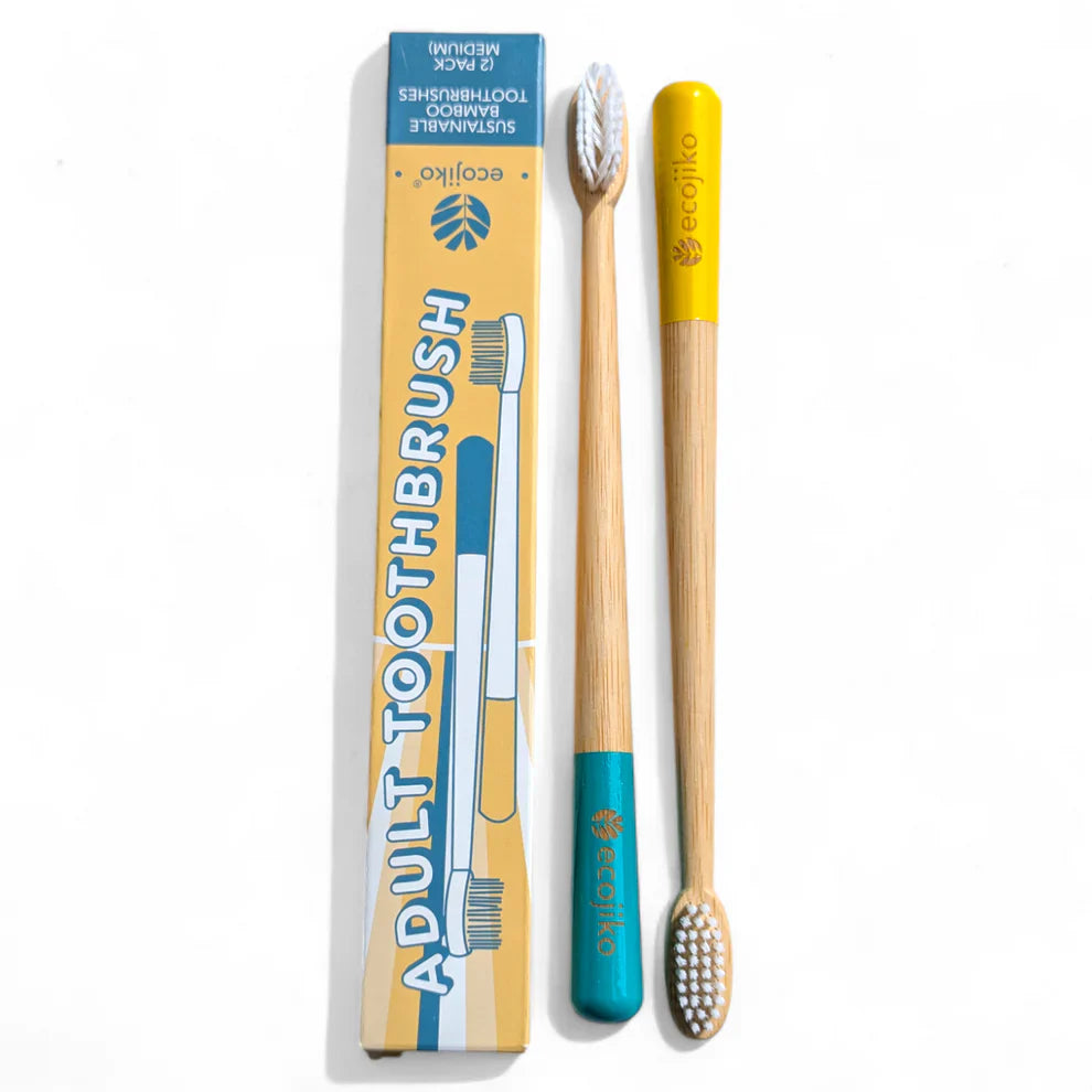 Sustainable bamboo toothbrushes with medium bristles, featuring yellow and turquoise painted tips