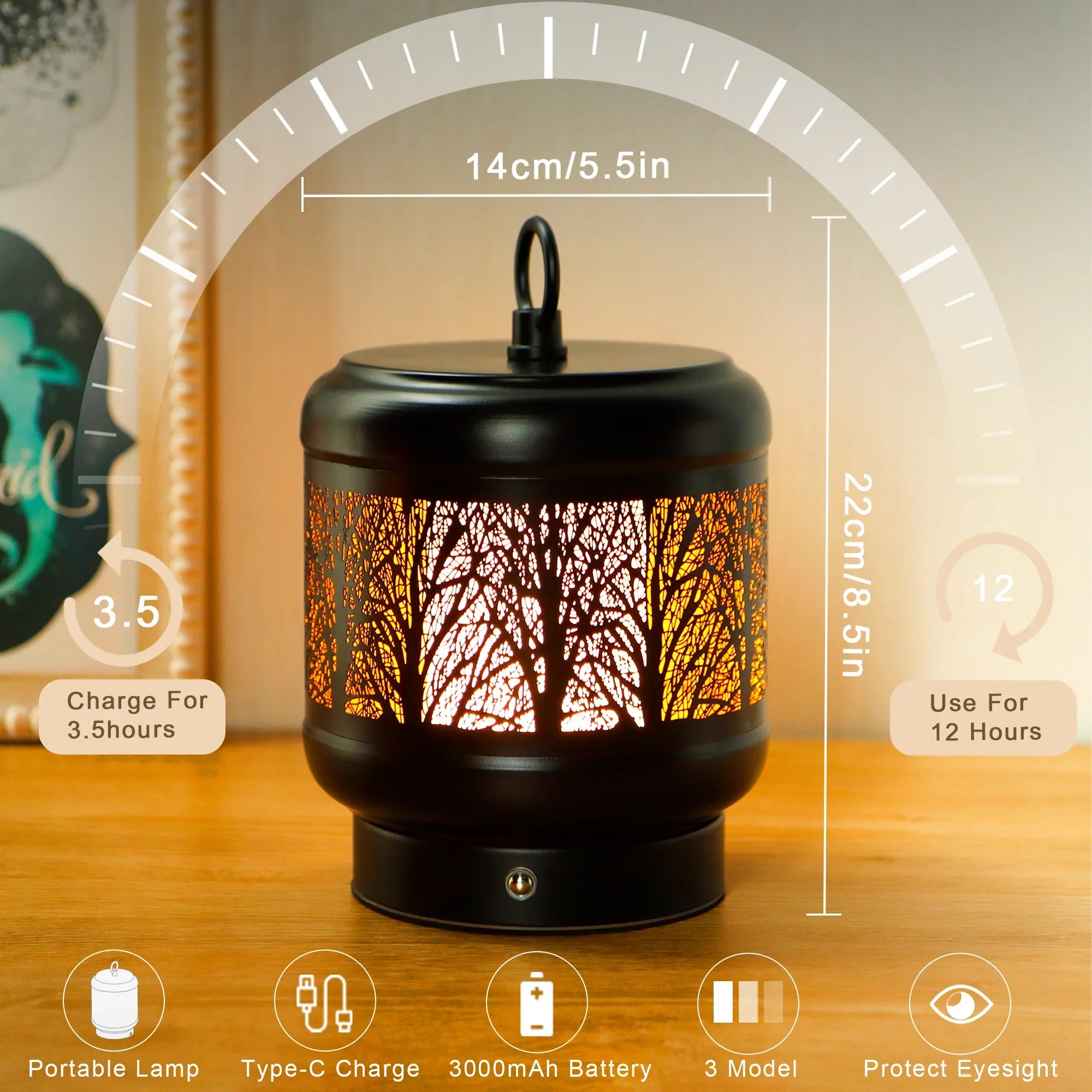 Rechargeable metal desk lamp with tree silhouette cutouts glowing in warm light on a table — view 2