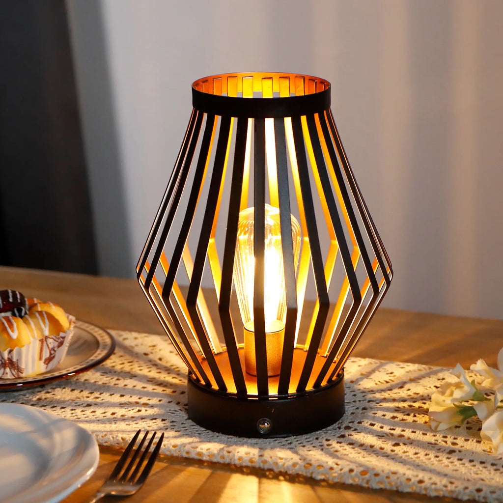 Set of two vintage bronze metal cage table lamps with warm glowing bulbs — view 2