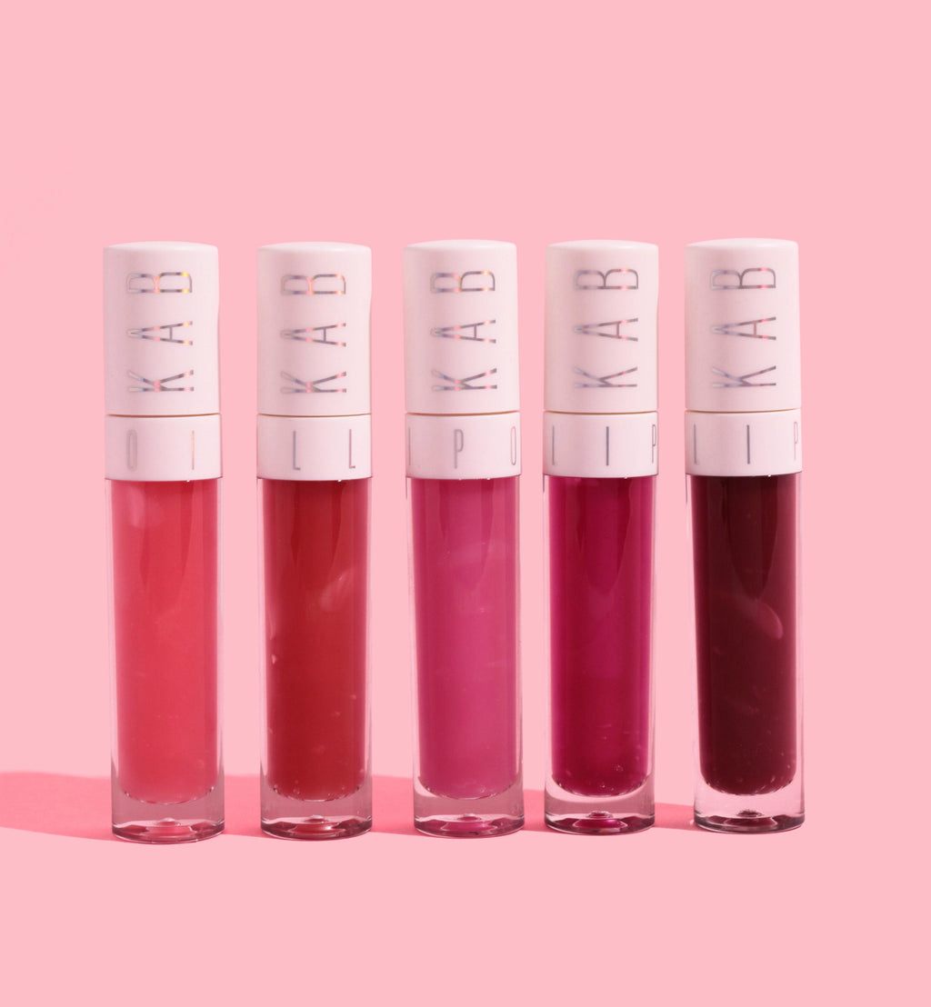 Hydrating tinted lip oil tube with large doe foot applicator and glossy pink sheen — view 2