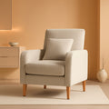 Beige upholstered contemporary accent chair with rubberwood legs and a cushioned lumbar support pillow.
