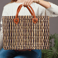 Handwoven Moroccan wicker tote bag with sturdy genuine leather handles for shopping and everyday use