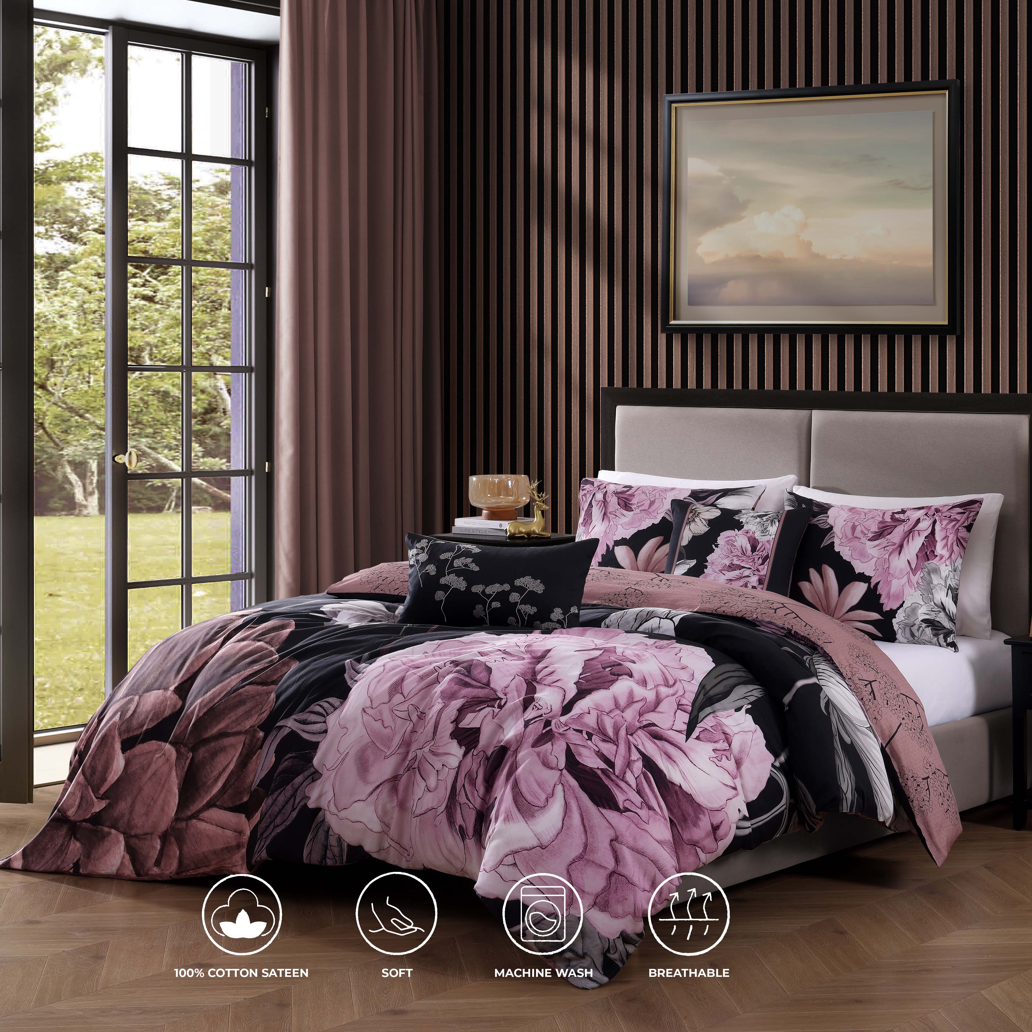 Black and pink floral reversible cotton comforter set with shams and decorative pillows on bed — view 2