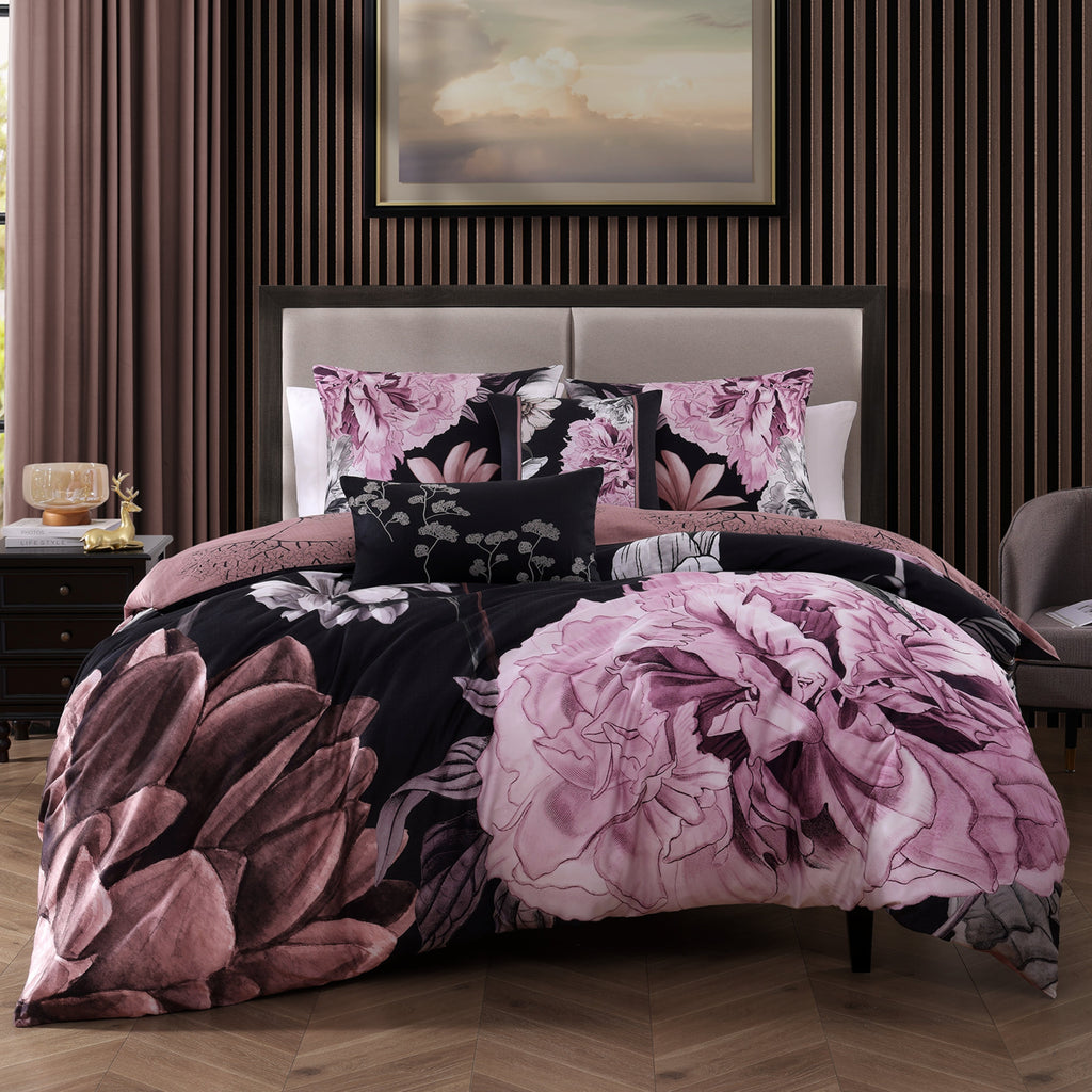 Black and pink floral reversible cotton comforter set with shams and decorative pillows on bed