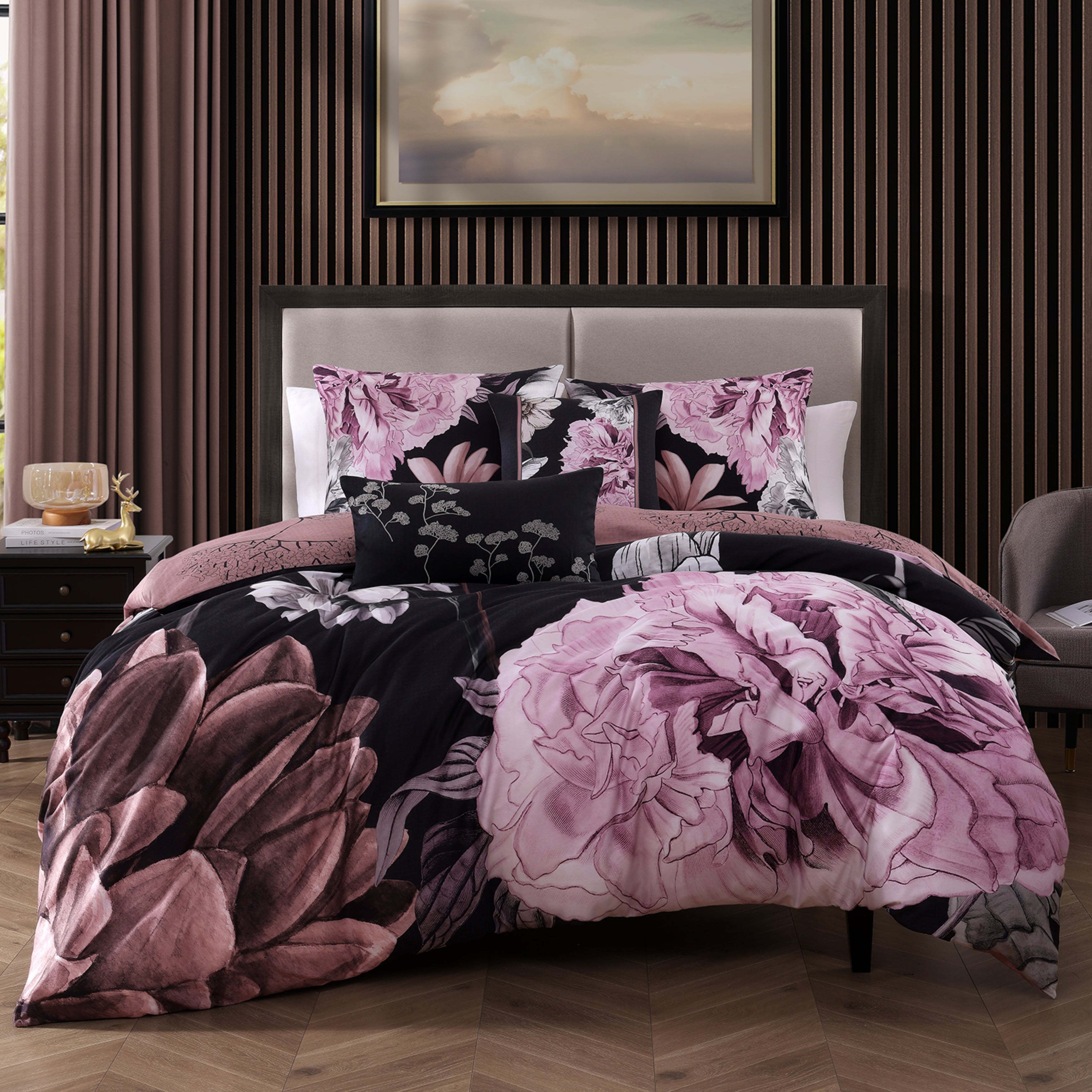 Black and pink floral reversible cotton comforter set with shams and decorative pillows on bed