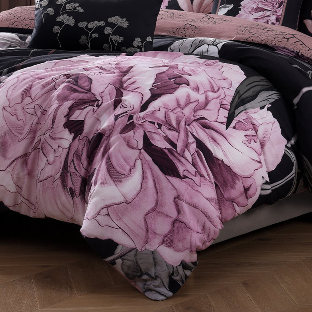 Black and pink floral reversible cotton comforter set with shams and decorative pillows on bed — view 3