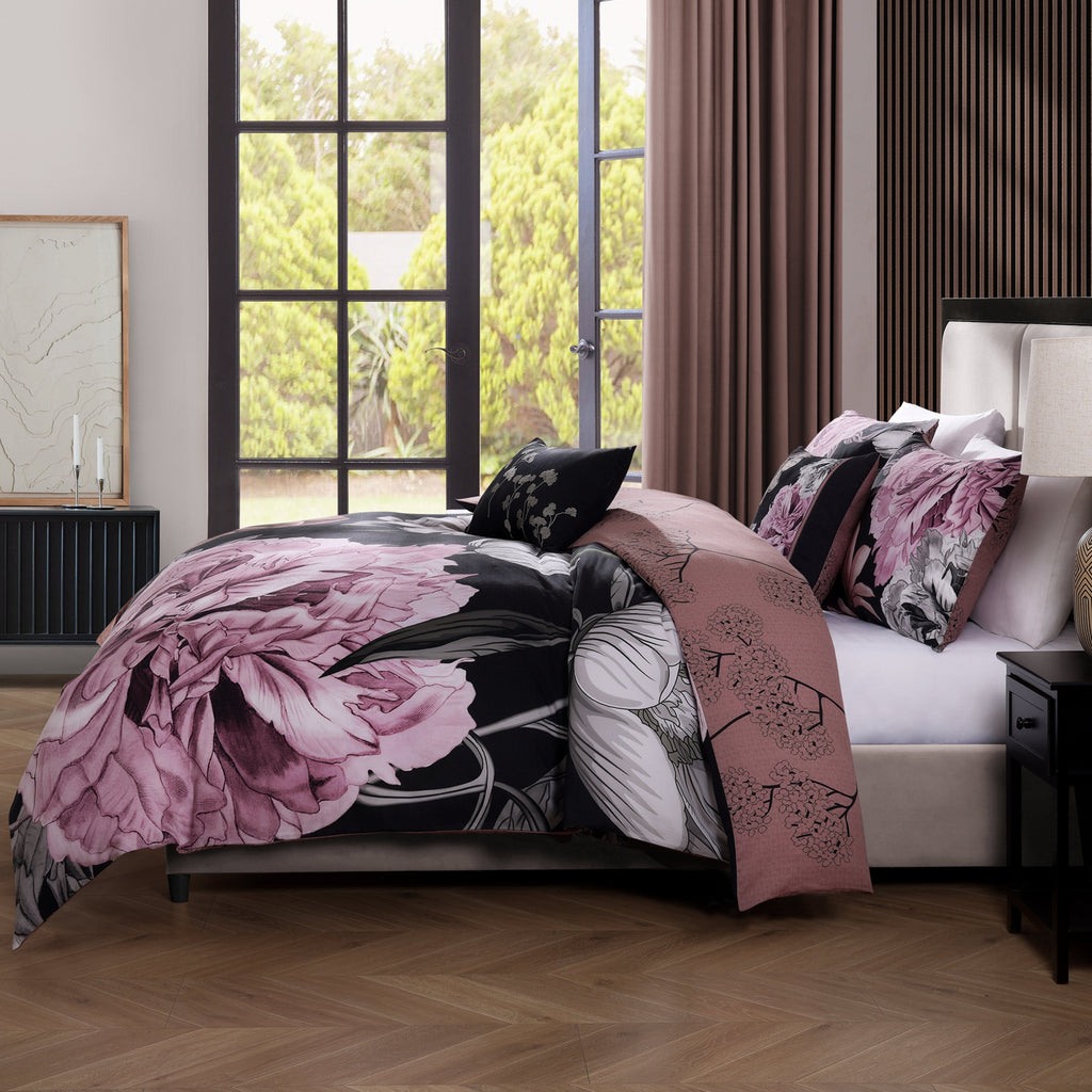 Black and pink floral reversible cotton comforter set with shams and decorative pillows on bed — view 5