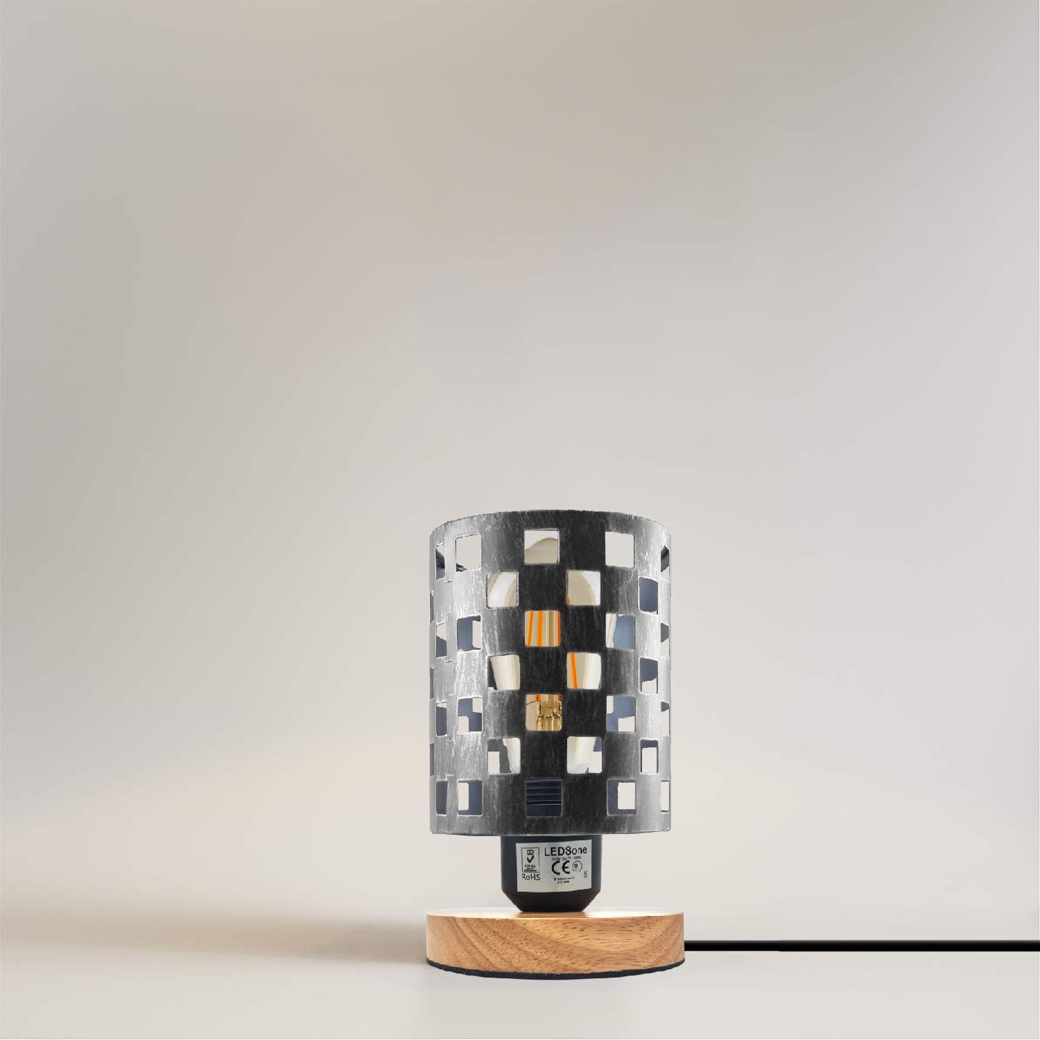 Antique brass bedside table lamp with wood base and metal wire cage cylinder design.