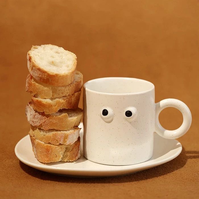 Handmade ceramic coffee mug featuring a funny big eyes cartoon design and a sturdy handle — view 2