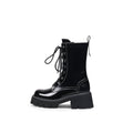 Black leather lace up combat boots with patent shine, block heel, and sharp stitching detail