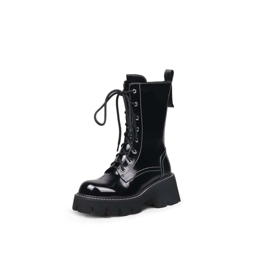 Black leather lace up combat boots with patent shine, block heel, and sharp stitching detail — view 2