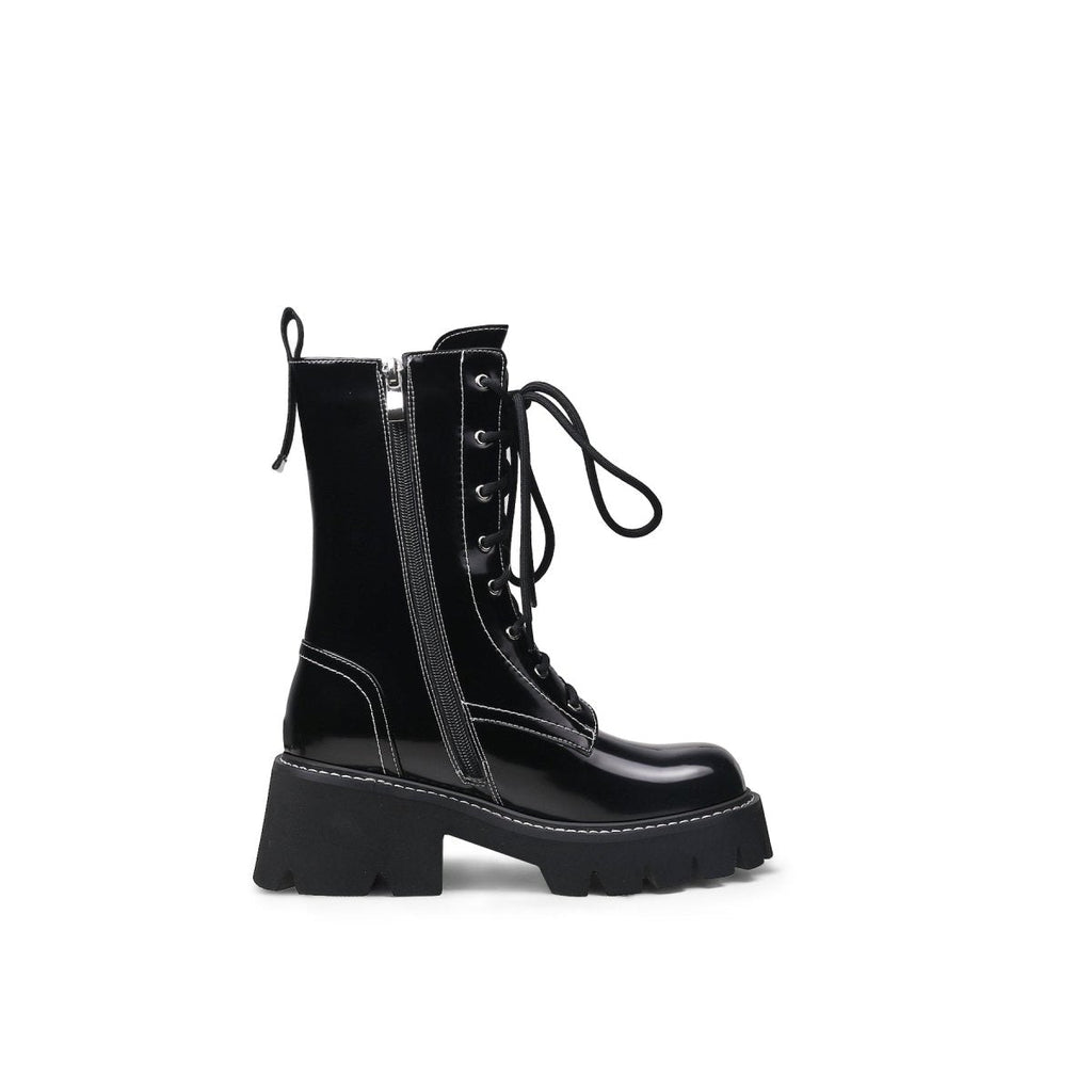 Black leather lace up combat boots with patent shine, block heel, and sharp stitching detail — view 3
