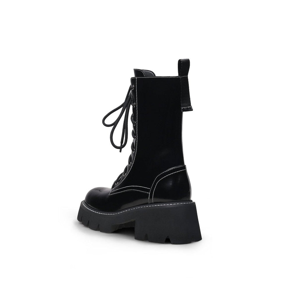 Black leather lace up combat boots with patent shine, block heel, and sharp stitching detail — view 4