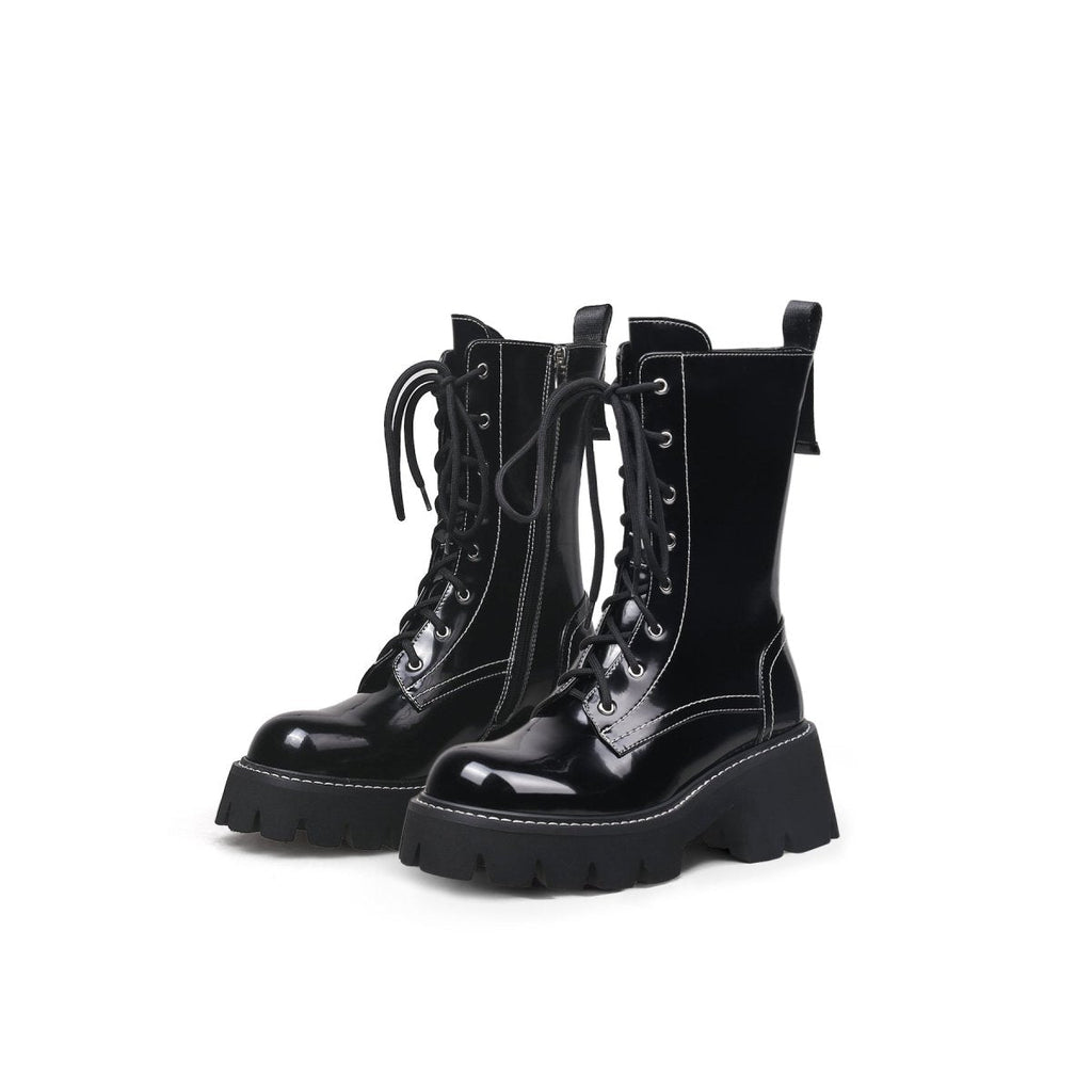 Black leather lace up combat boots with patent shine, block heel, and sharp stitching detail — view 5