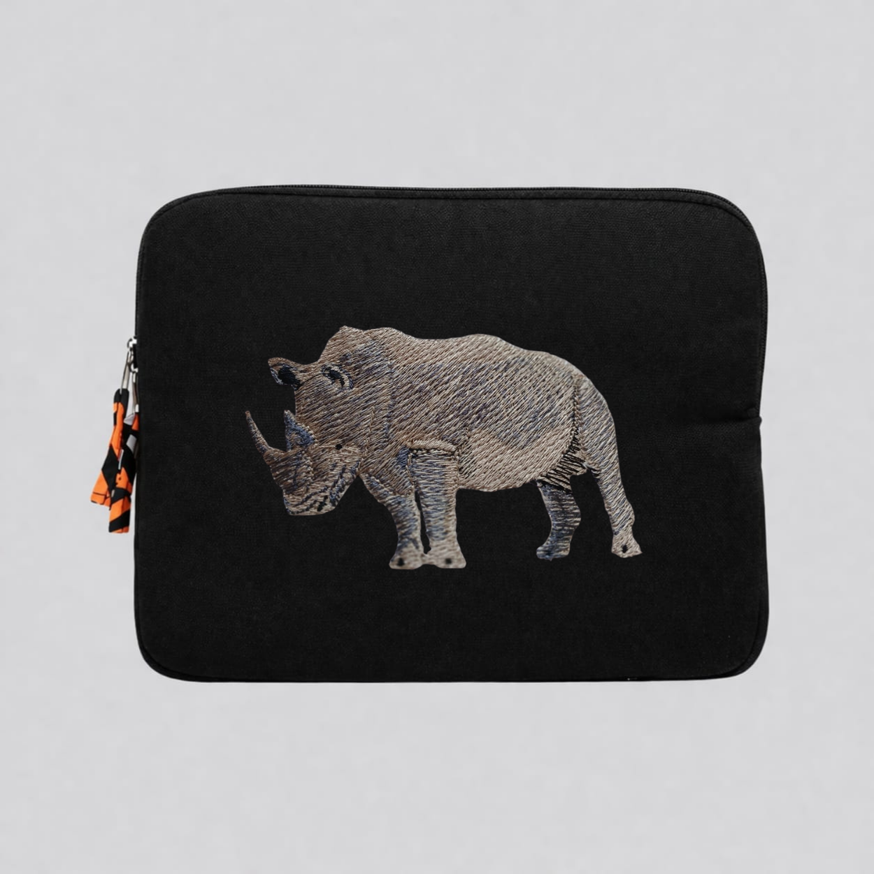 Rhino laptop sleeve made of Kenyan cotton canvas with animal embroidery in warm earthy colors — view 5