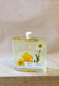 Botanical reed diffuser in elegant glass bottle featuring natural reeds and premium essential oils
