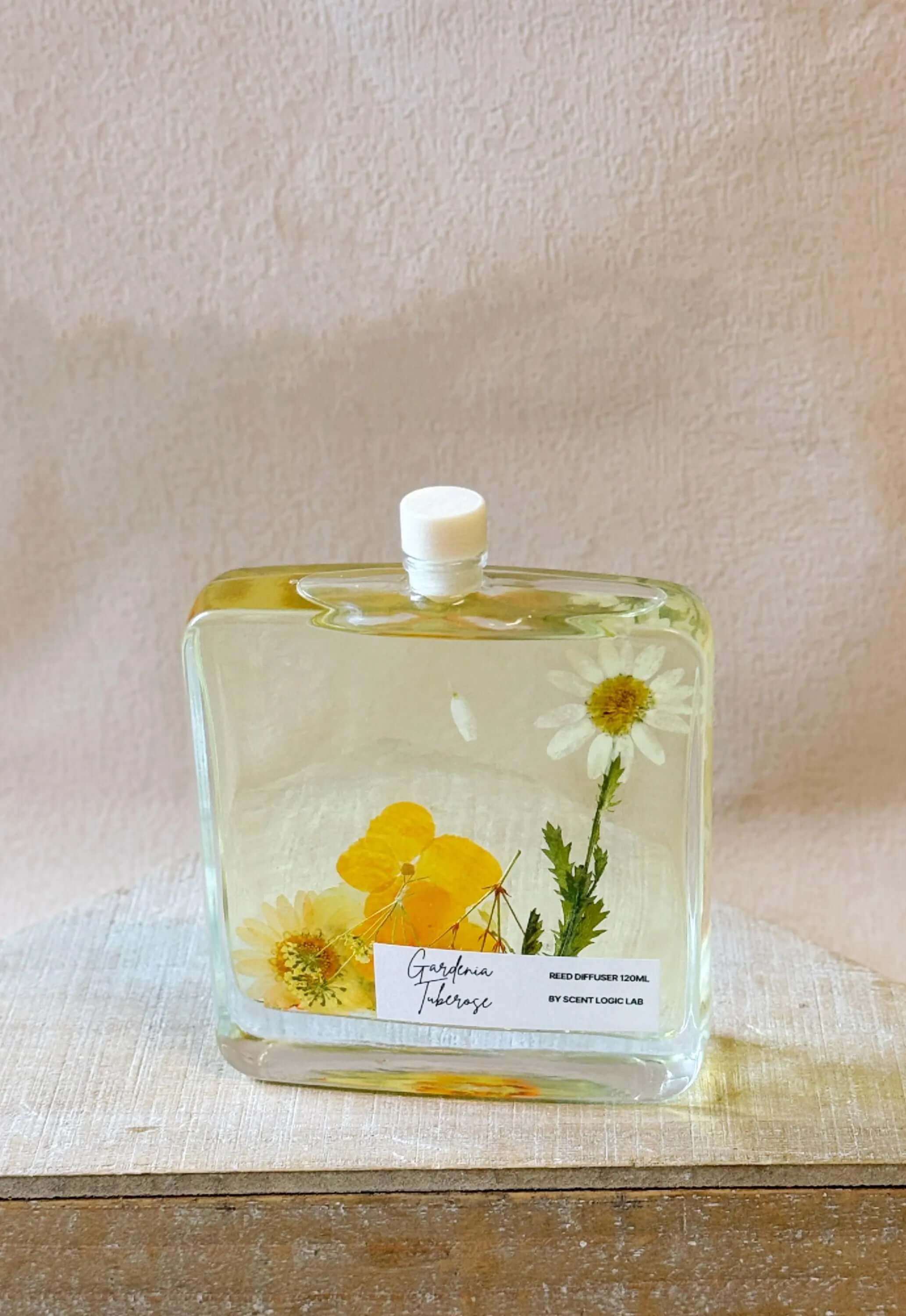 Botanical reed diffuser in elegant glass bottle featuring natural reeds and premium essential oils