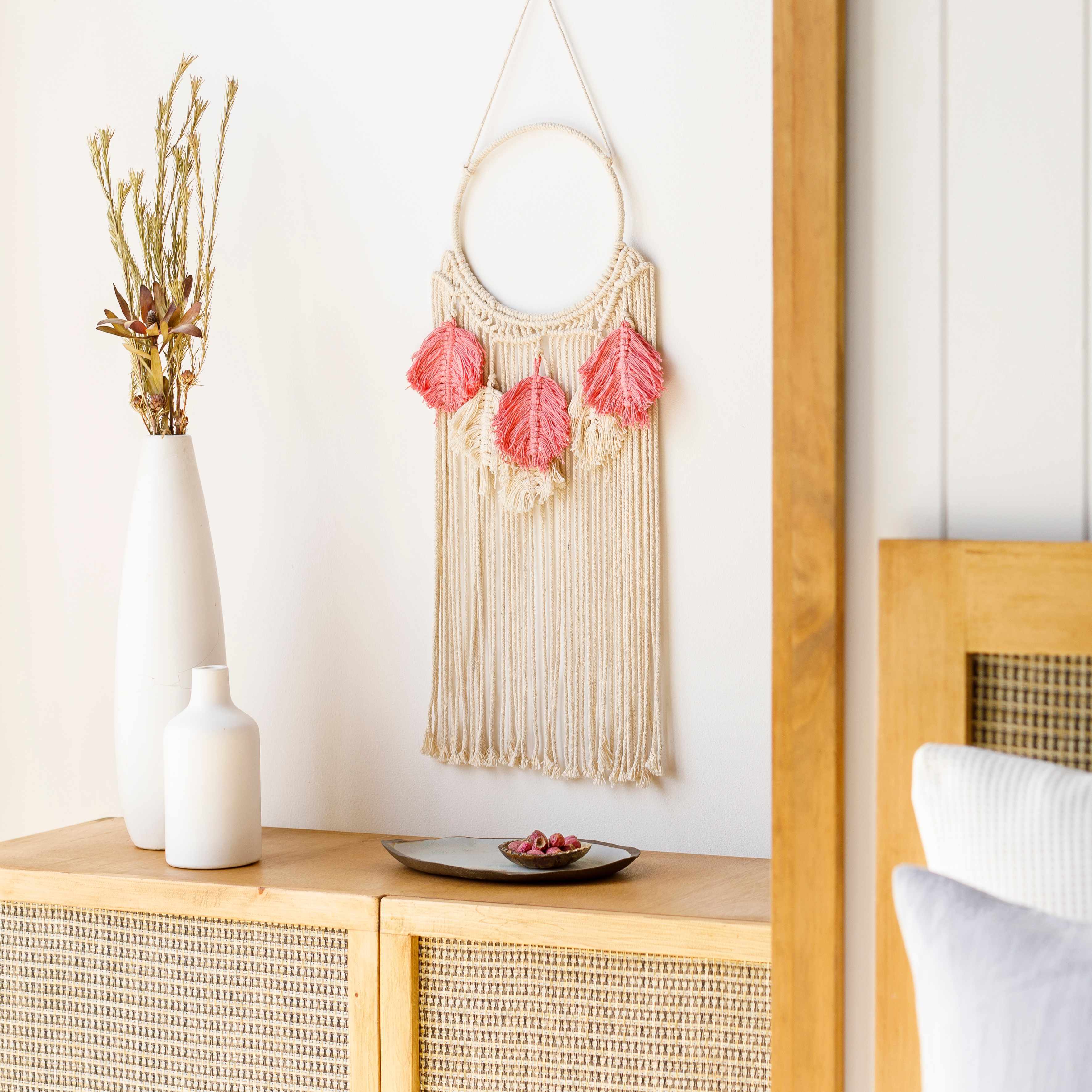 Blush pink and ivory hand woven boho cotton tassel wall hanging on a metal rod — view 5