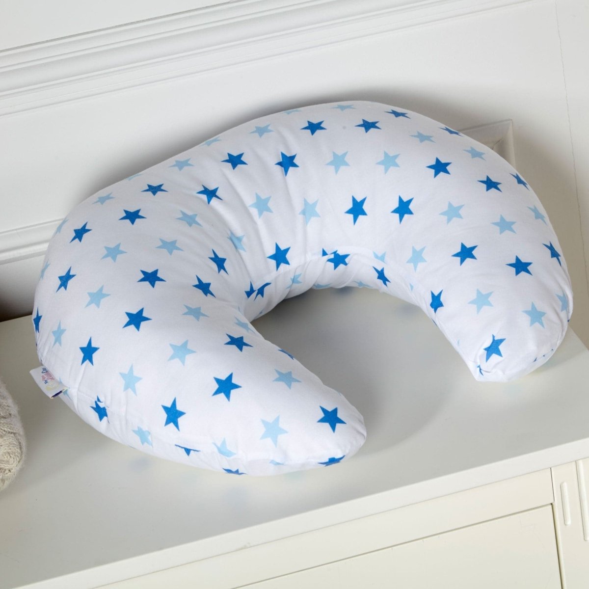 Light blue breastfeeding nursing pillow cover with white star pattern and secure side zipper closure