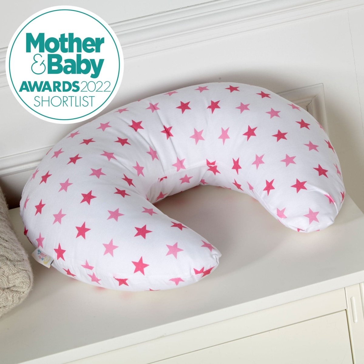 Soft pink breastfeeding nursing pillow cover featuring a delicate white star pattern and zipper — view 2
