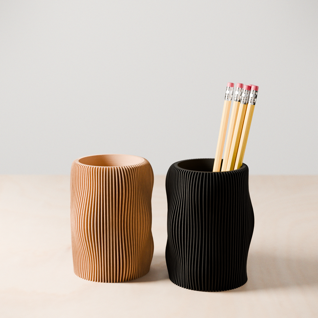 Wavy textured modern pencil holder organizing pens on a desk, made of eco-friendly materials. — view 2