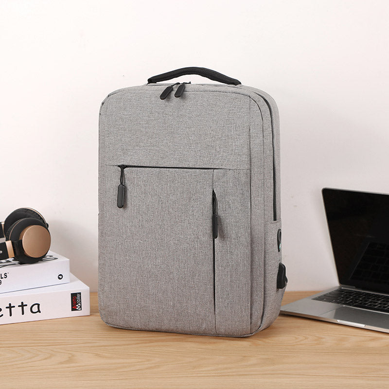 Premium grey minimalist travel backpack with padded straps and sleek modern design for daily commute — view 3
