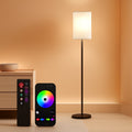Tall smart LED floor lamp with black pole, white shade, and RGB color changing ambient light