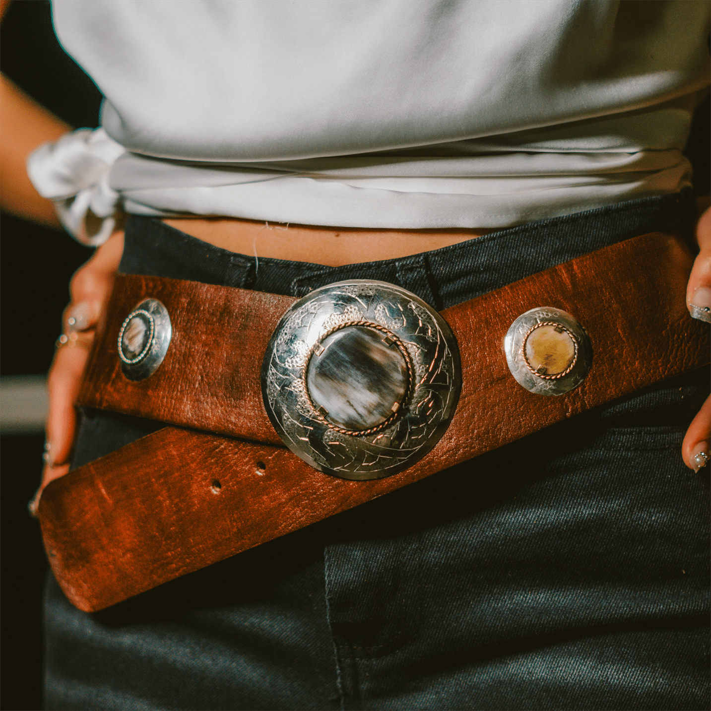 Genuine Moroccan leather belt featuring a patinated copper and bone buckle on a plain background
