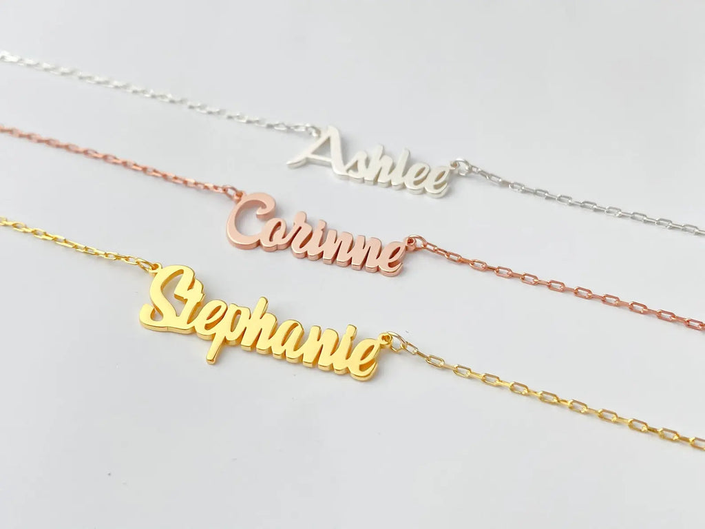 Personalized name necklace in elegant script font with a delicate gold chain and clasp.
