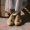 Handcrafted Ladame raffia slippers with woven textured upper and durable leather sole