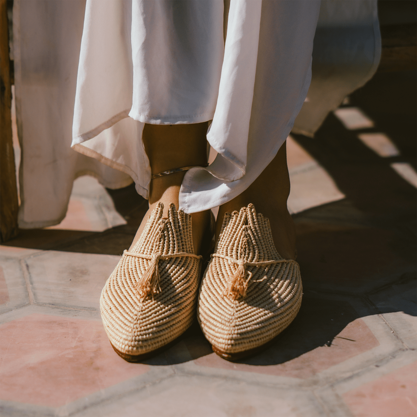 Handcrafted Ladame raffia slippers with woven textured upper and durable leather sole