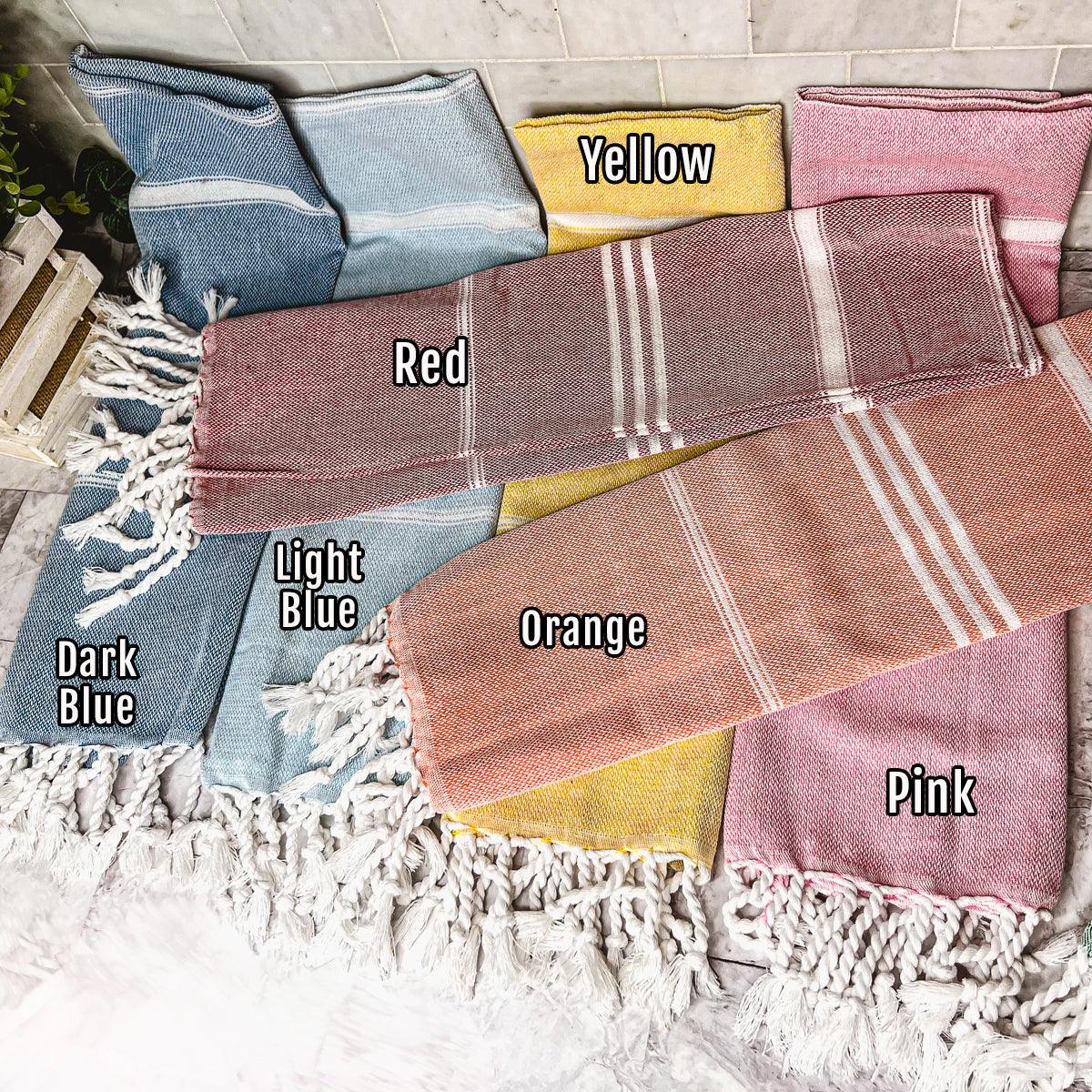 Oversized Turkish hand towel in premium cotton with natural bamboo tassels folded on a flat surface — view 3