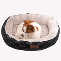 Sleek black CozyPaws round dog bed with washable cloth cover in a modern home setting