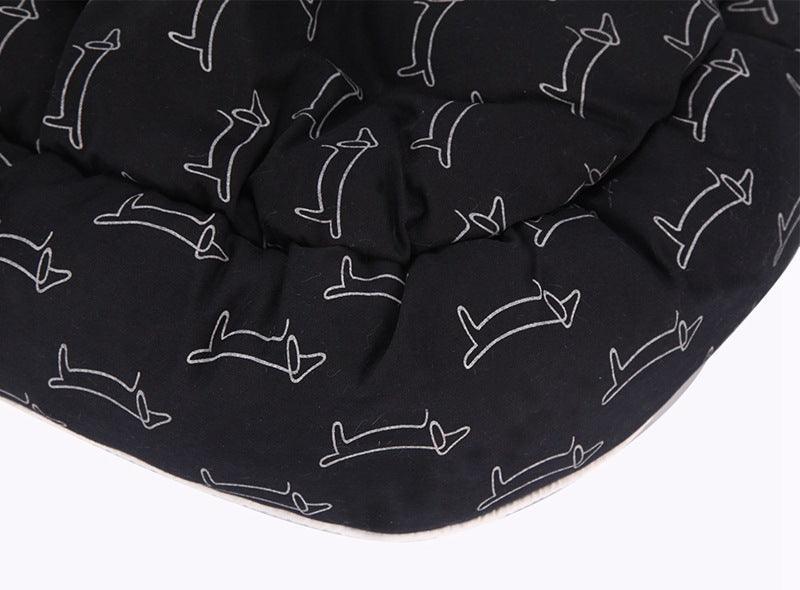 Sleek black CozyPaws round dog bed with washable cloth cover in a modern home setting — view 3