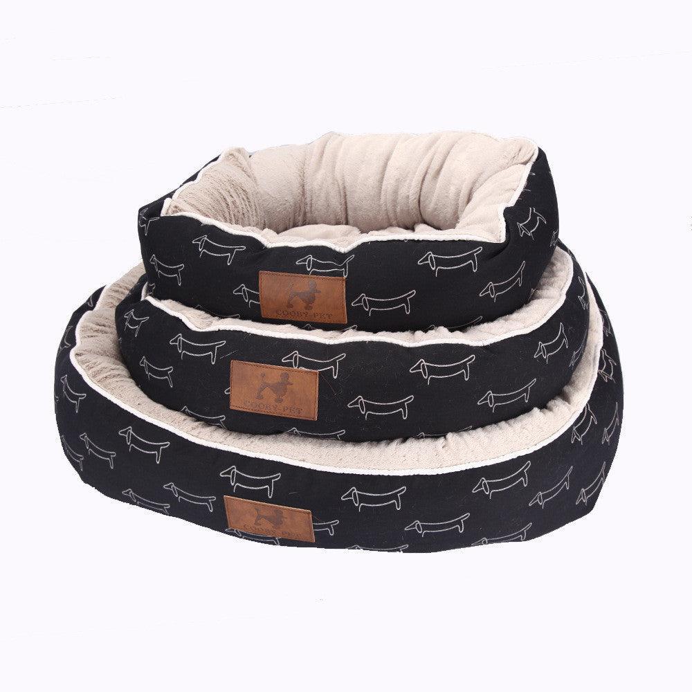 Sleek black CozyPaws round dog bed with washable cloth cover in a modern home setting — view 4