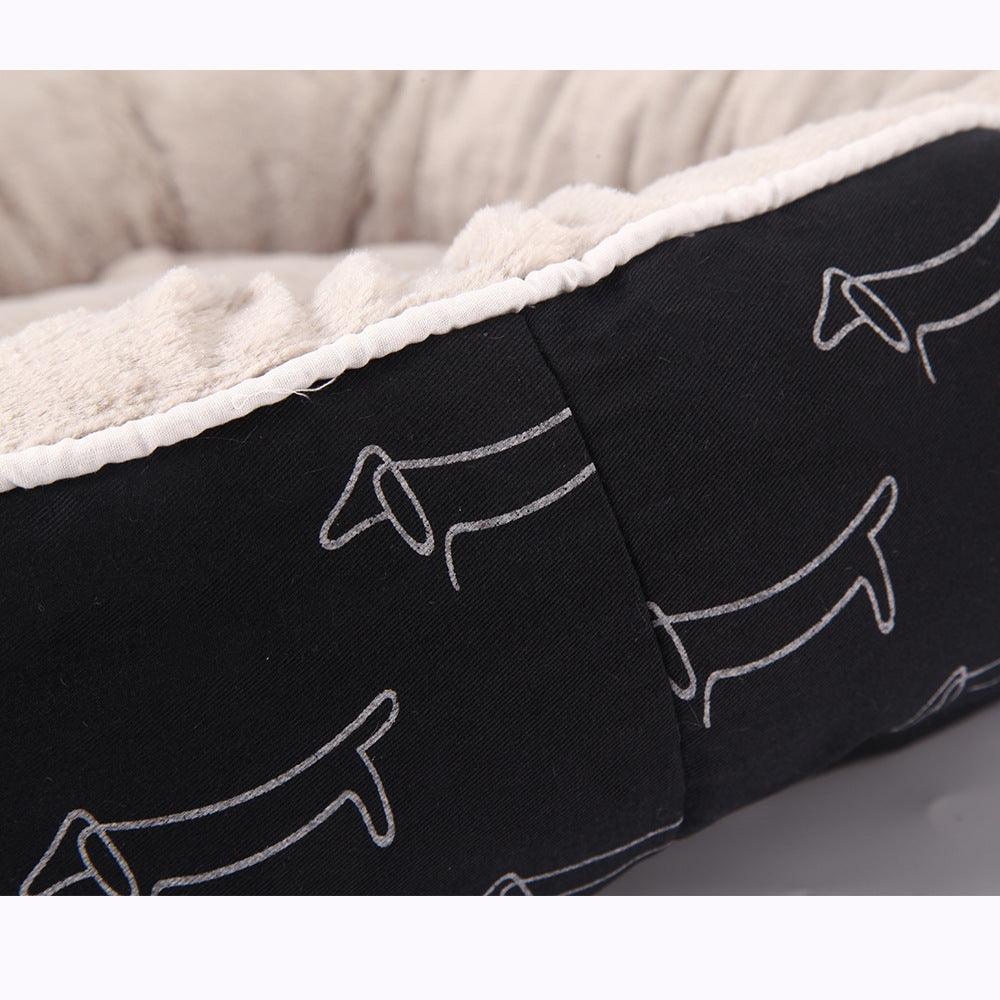 Sleek black CozyPaws round dog bed with washable cloth cover in a modern home setting — view 2