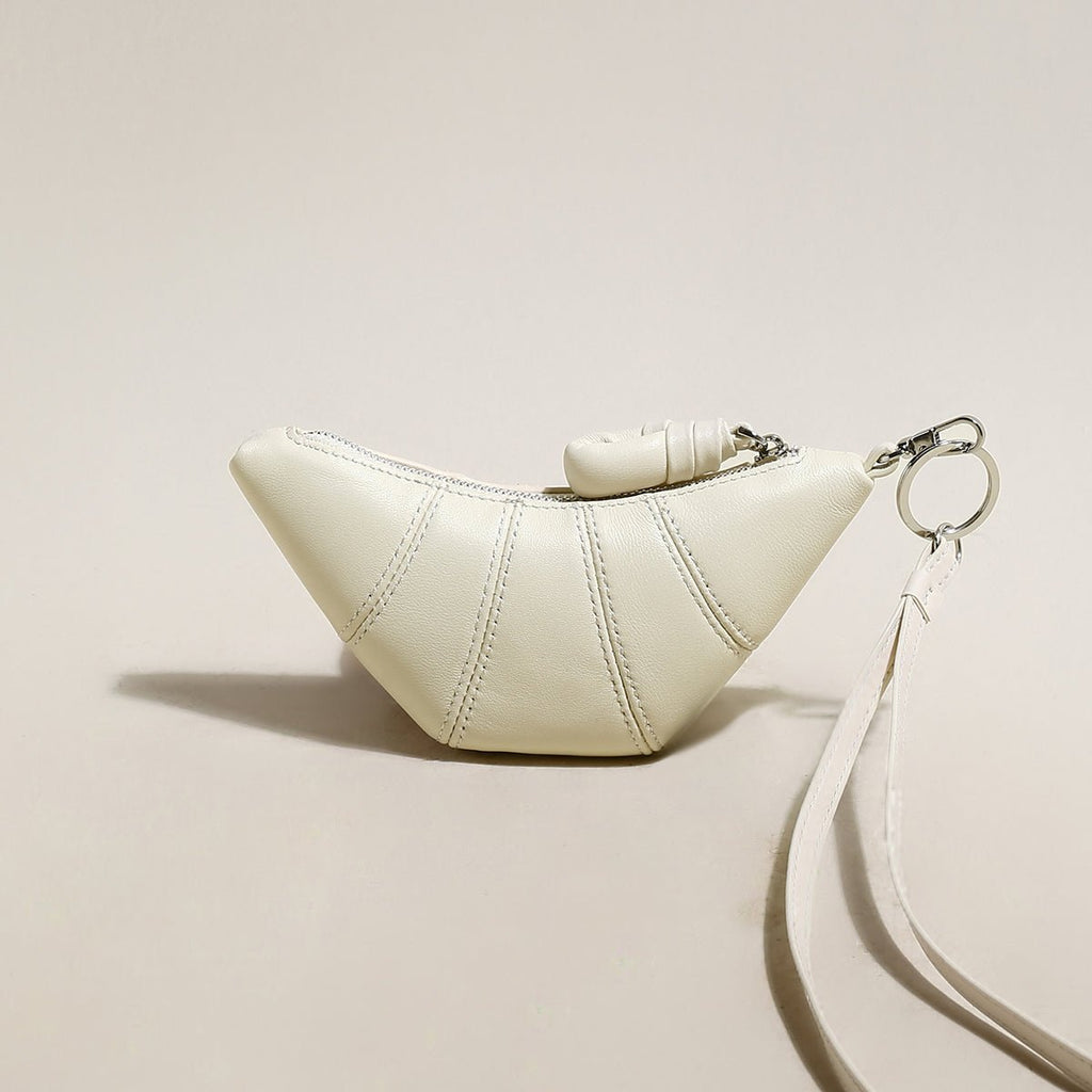 Soft vegan leather croissant mini pouch bag charm with wrist strap and zipper closure. — view 3