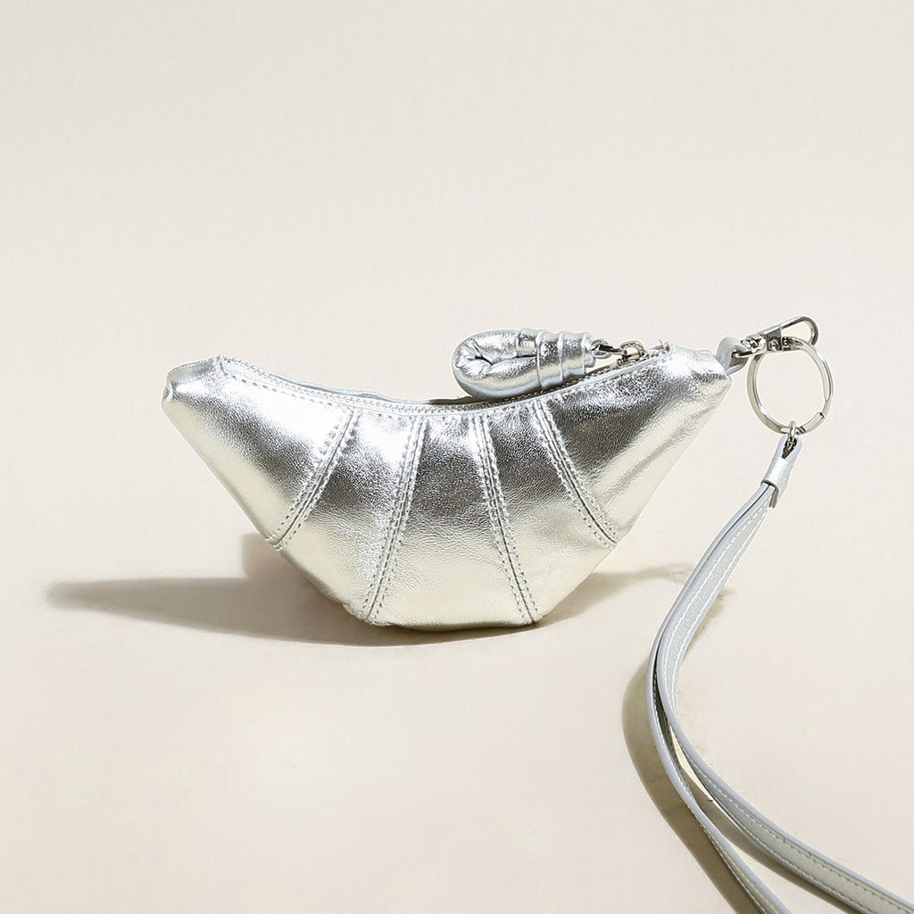 Soft vegan leather croissant mini pouch bag charm with wrist strap and zipper closure. — view 4