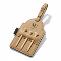 Custom leatherette golf bag tag with strap and three wooden tees on a solid background
