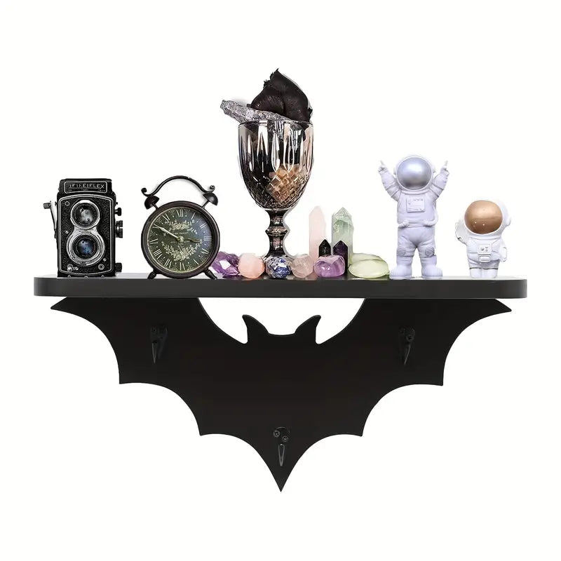 Black wooden bat shaped floating wall shelf featuring three metal key hooks for hanging gothic decor