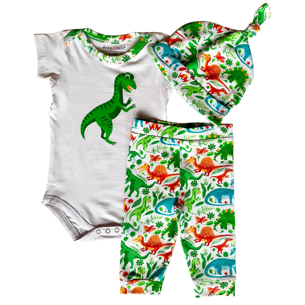 Baby boy 3-piece dinosaur layette set with bodysuit, green patterned joggers, and matching head cap