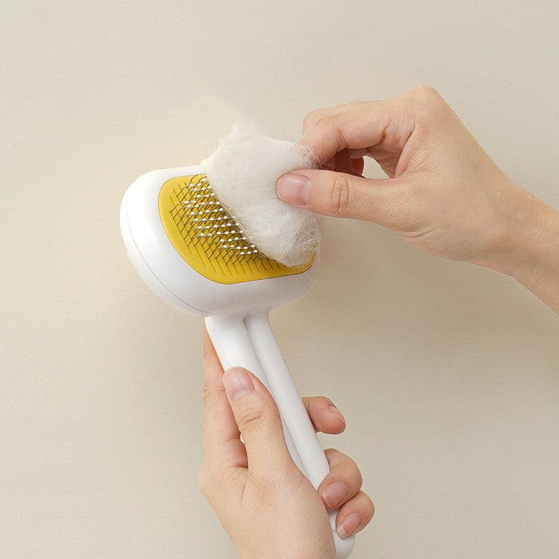 Ergonomic pet grooming comb with stainless steel bristles and a sleek capsule shape handle — view 4