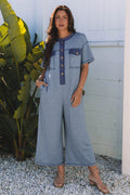 Womens blue wide leg short sleeve jumpsuit with half placket and functional chest pockets