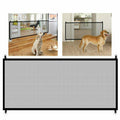 Black portable mesh pet safety gate with nylon barrier installed in home hallway