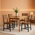 Four rustic brown wooden dining chairs with black industrial metal frames and ergonomic angled backrests