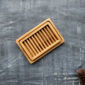Dual-layer bamboo soap dish featuring slotted drying rack and draining tray in natural wood finish